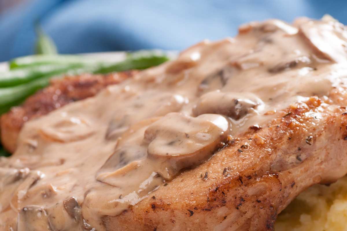 Pock chop with creamy mushroom sauce over potatoes, simple slow cooker recipe